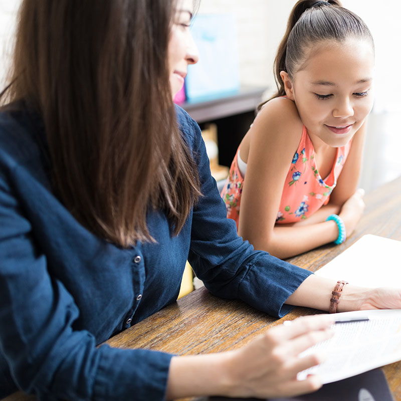 A female coaching teaching a young female student